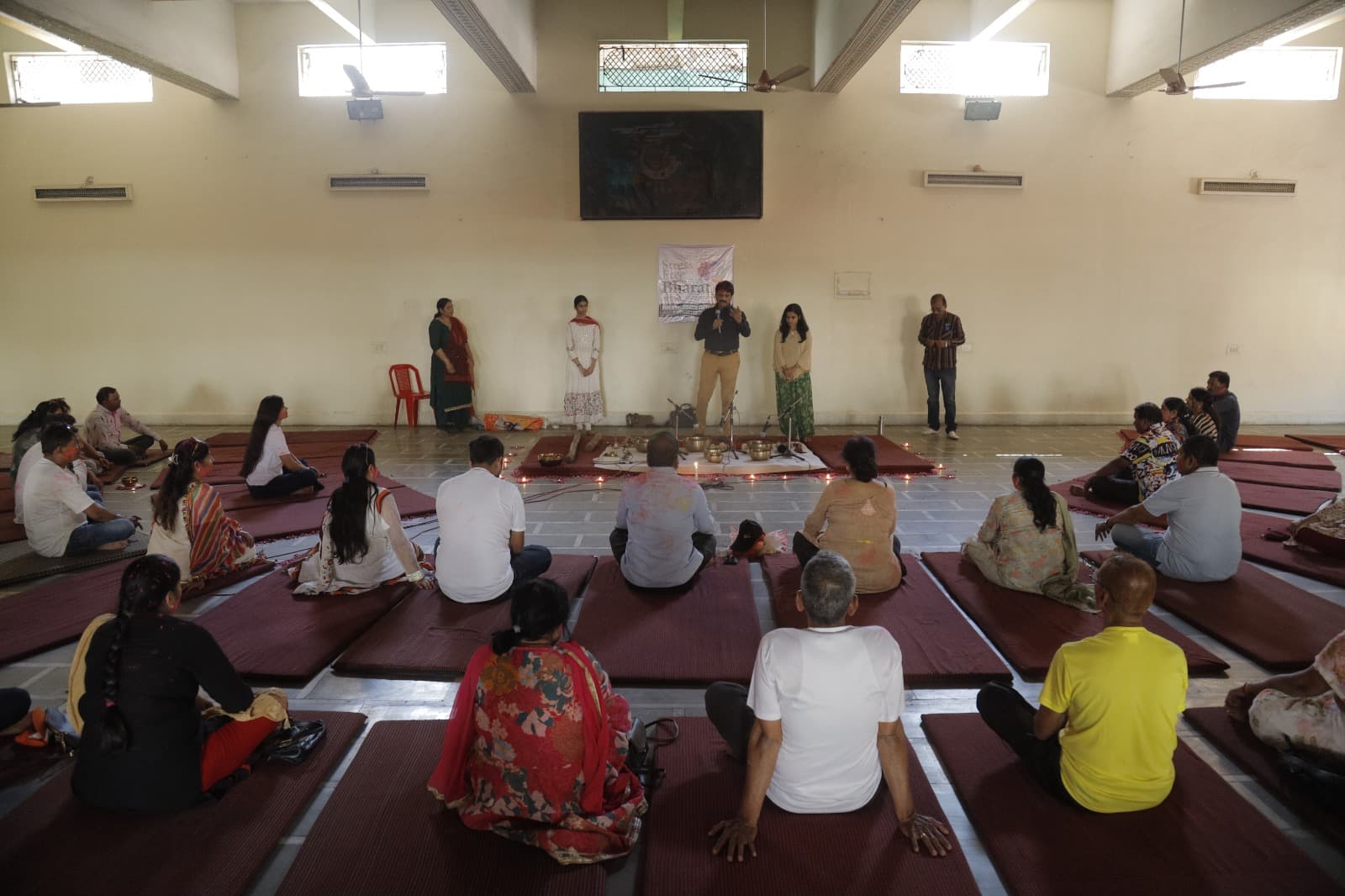 Group celebration on stage during a festive wellness event